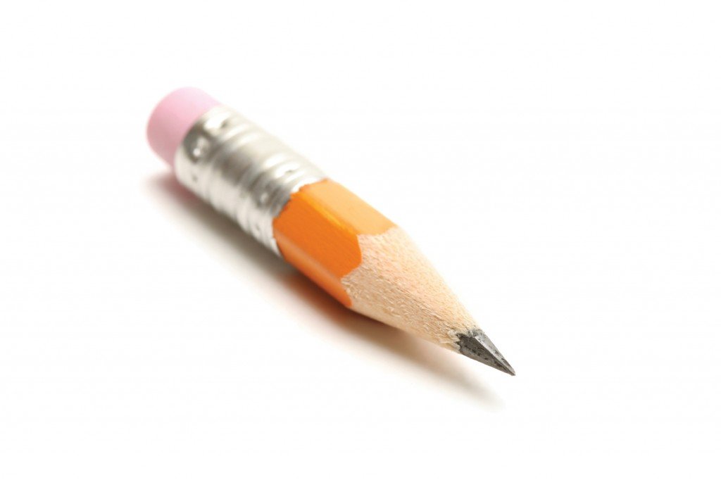 short yellow pencil shot over white. shallow dof with focus on tip.
