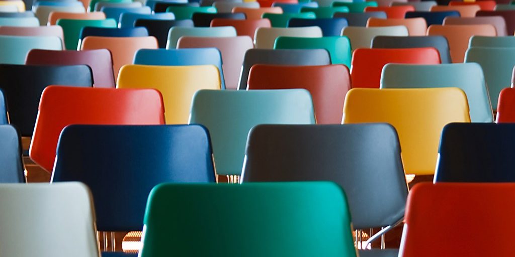 Presentation hall with rows of colored chairs