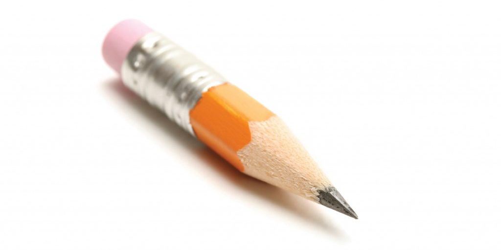 short yellow pencil shot over white. shallow dof with focus on tip.